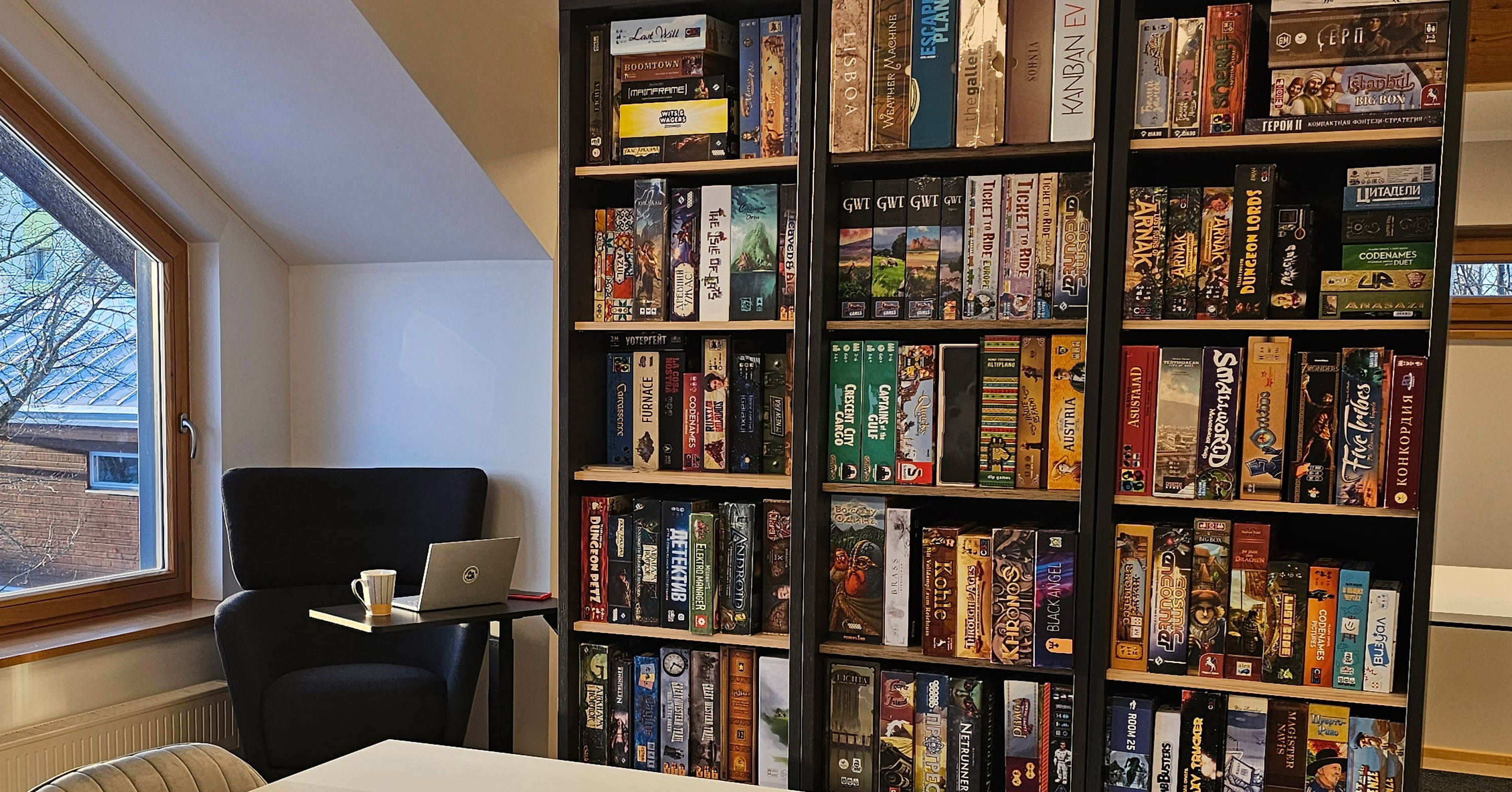 Board game collection shelves at Undercover Vibe game club